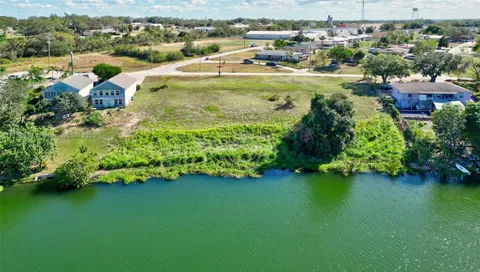 an aerial view of a houses with a lake view