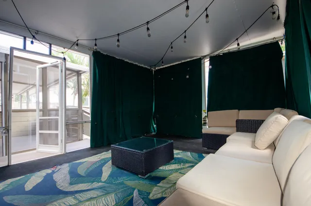 a living room with furniture and a floor to ceiling window