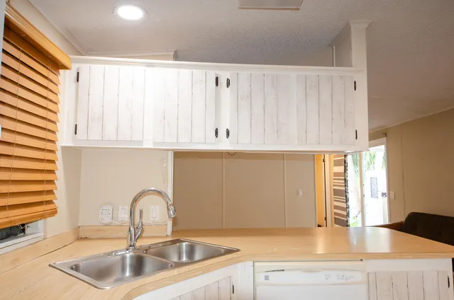 a kitchen with a sink and cabinets
