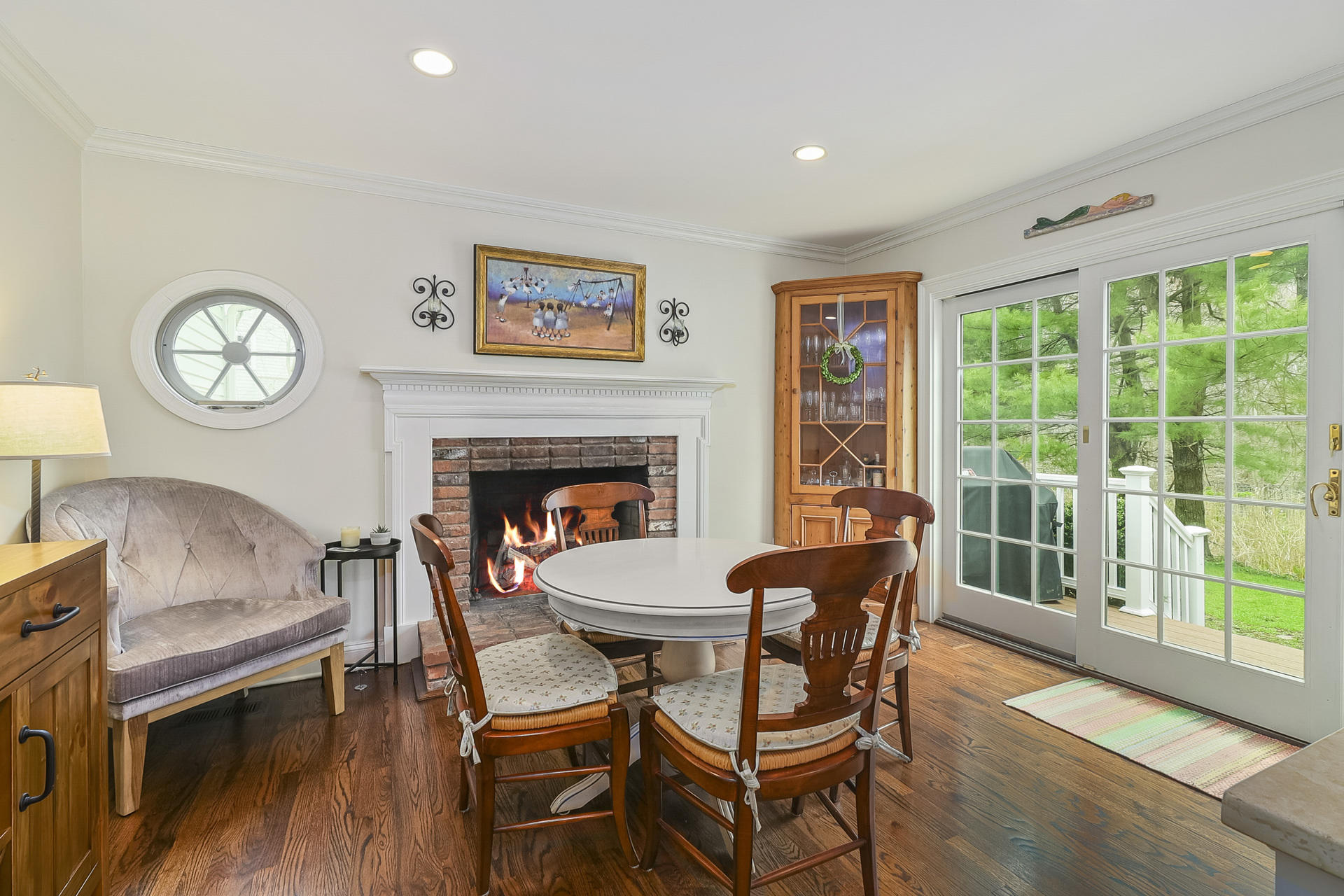 37 Red Rose Circle Darien, CT 06820 - Photo 11 of 40 a dining room with furniture a fireplace and wooden floor
