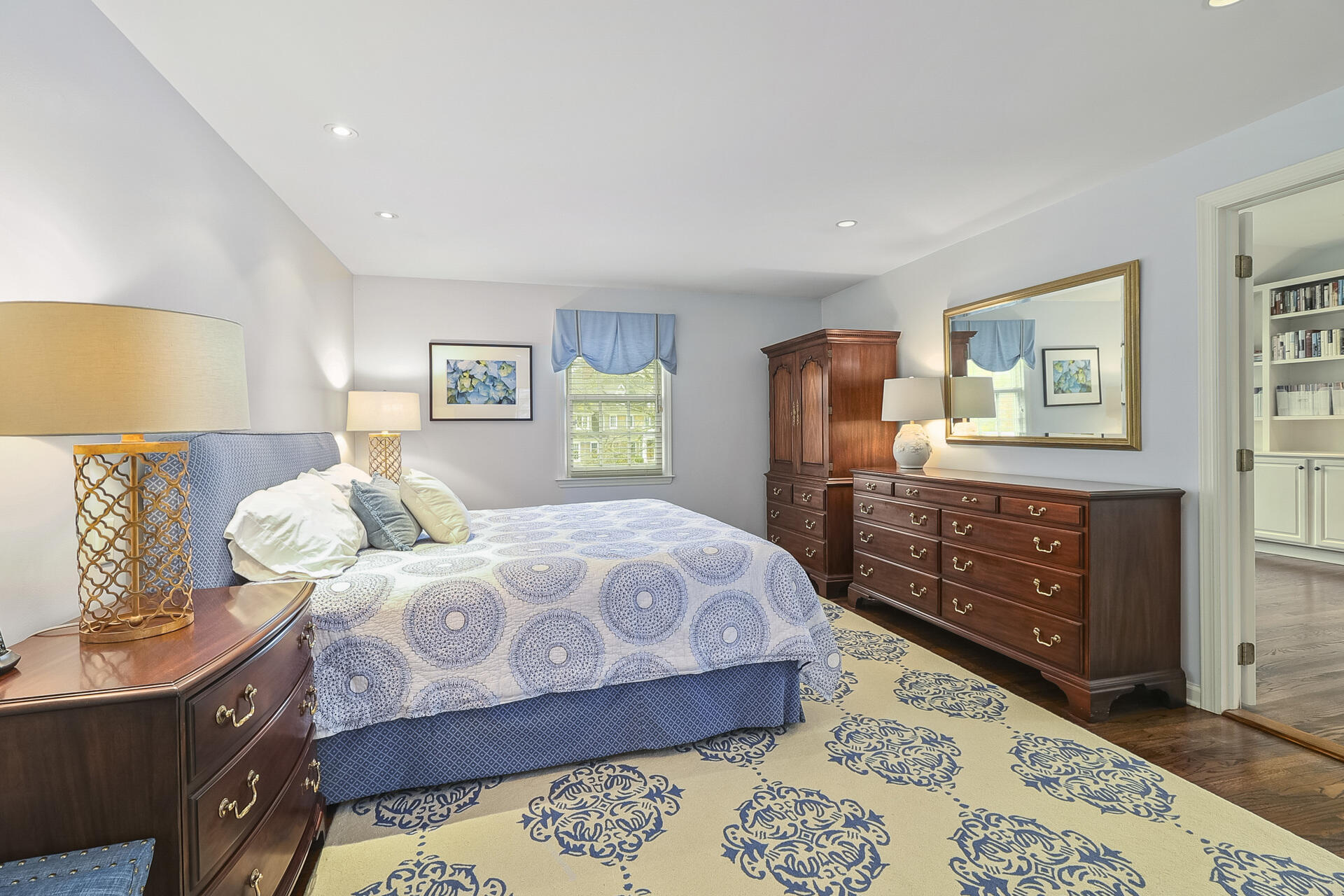 37 Red Rose Circle Darien, CT 06820 - Photo 18 of 40 a bedroom with a bed and wooden floor