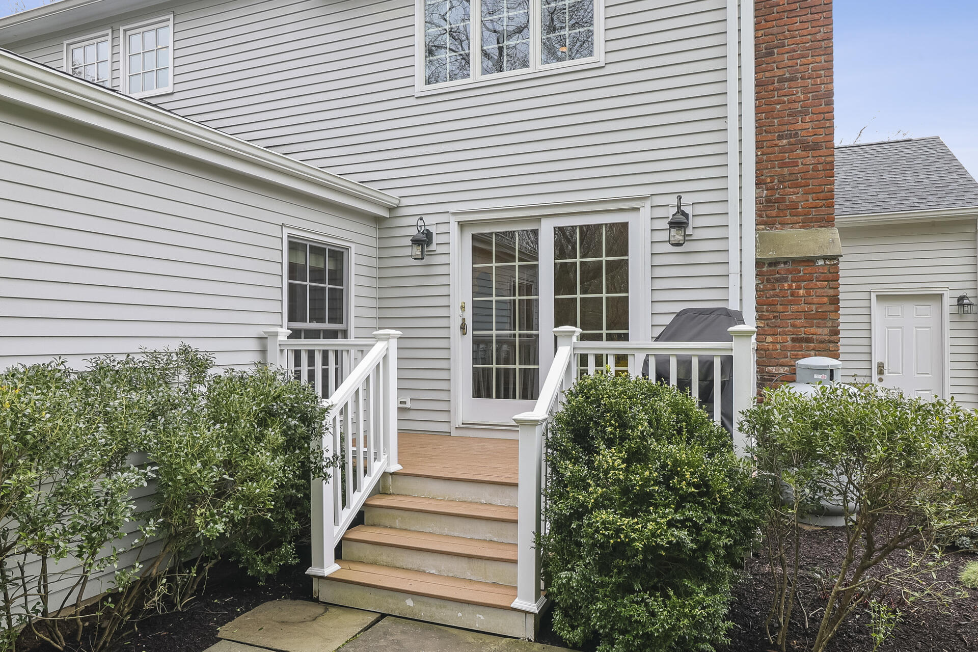 37 Red Rose Circle Darien, CT 06820 - Photo 34 of 40 a view of a house with more windows and plants