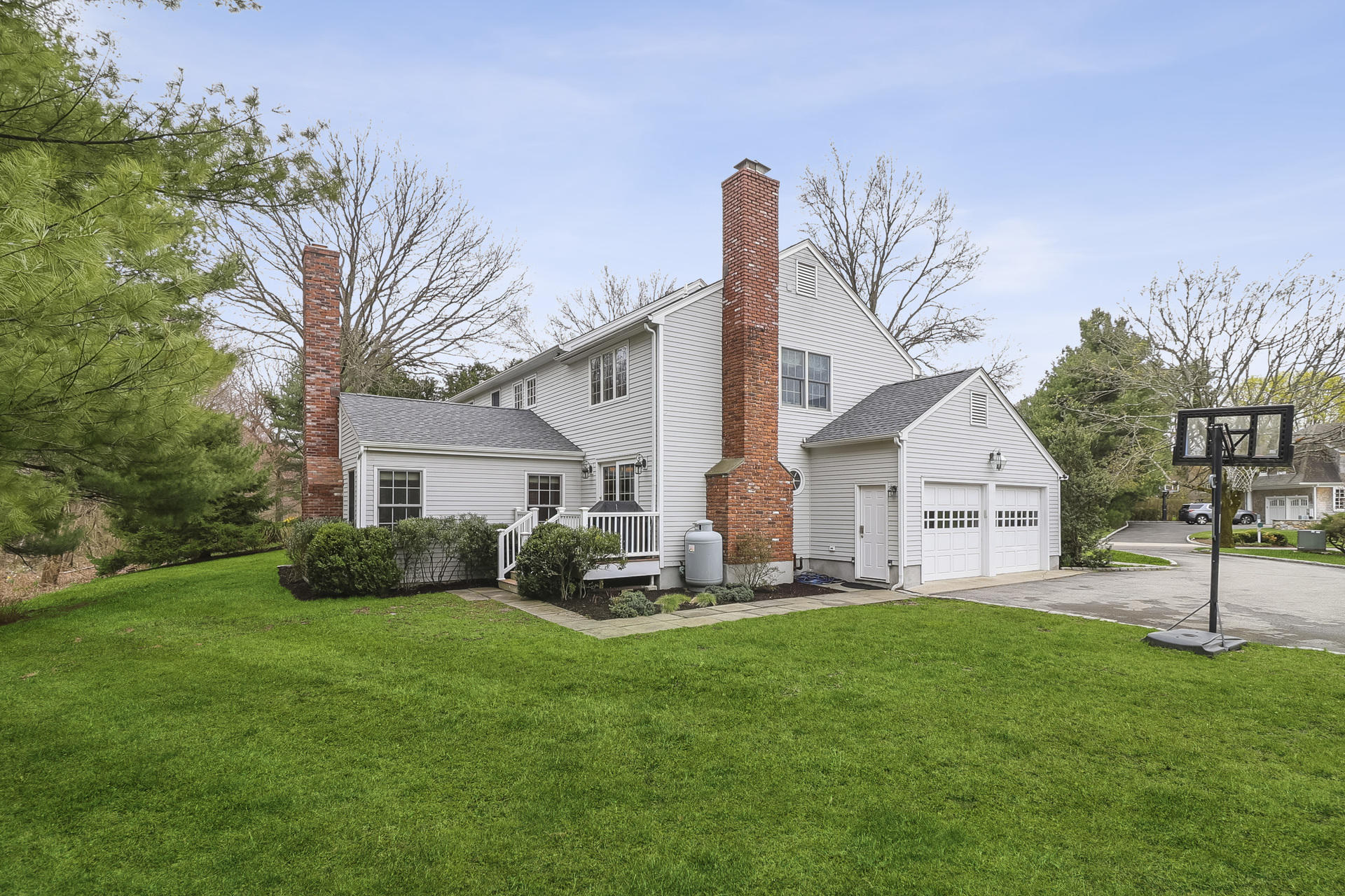 37 Red Rose Circle Darien, CT 06820 - Photo 36 of 40 a front view of a house with a yard and trees