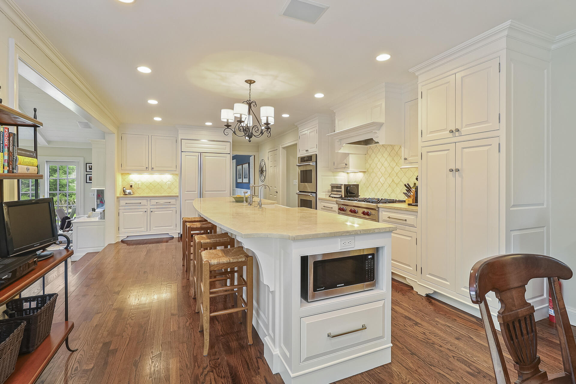 37 Red Rose Circle Darien, CT 06820 - Photo 9 of 40 a large kitchen with kitchen island a stove a table and chairs in it