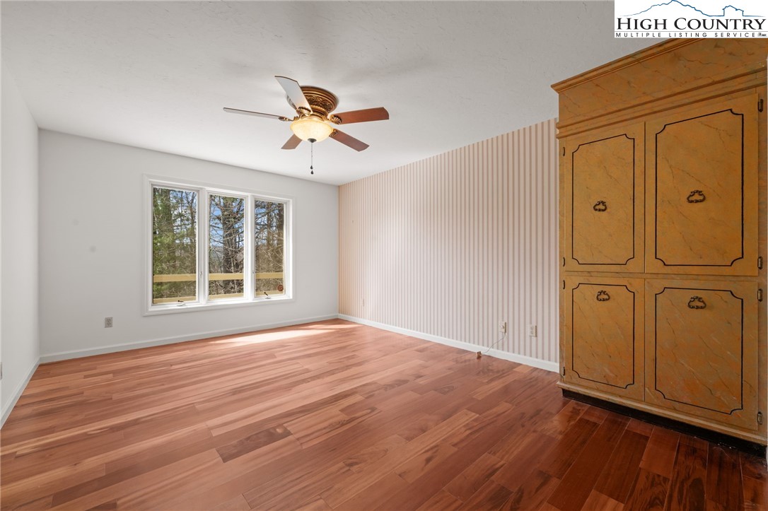 304 Glendale Drive Boone, NC 28607 - Photo 30 of 50 a view of empty room with wooden floor and fan