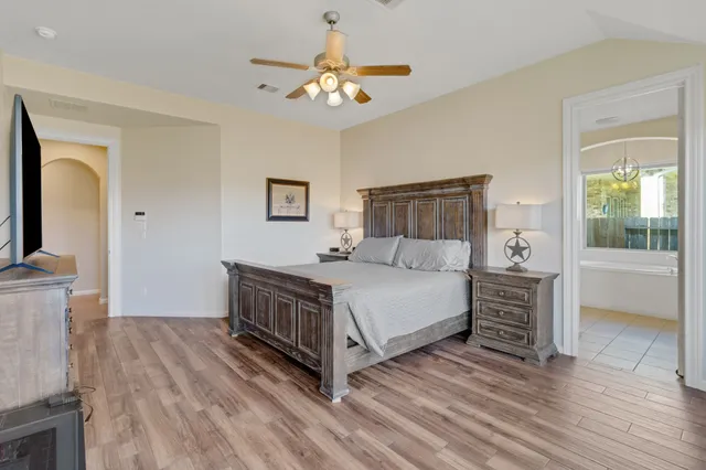 a bed room with a bed and a large window