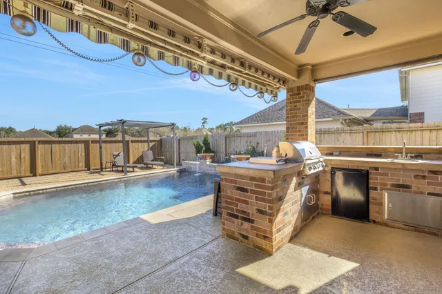 a living room with stainless steel appliances kitchen island granite countertop furniture and a kitchen view