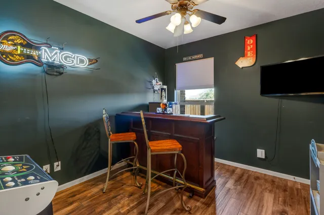 a room with pool table and a chandelier