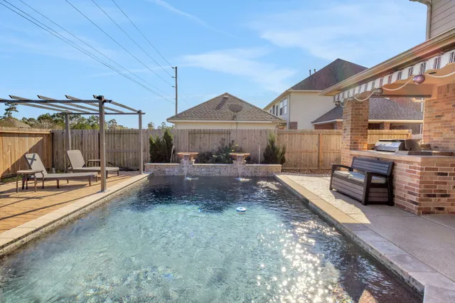 a view of a house with backyard and sitting area