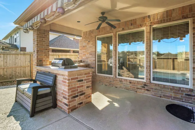 a view of a house with backyard and sitting area