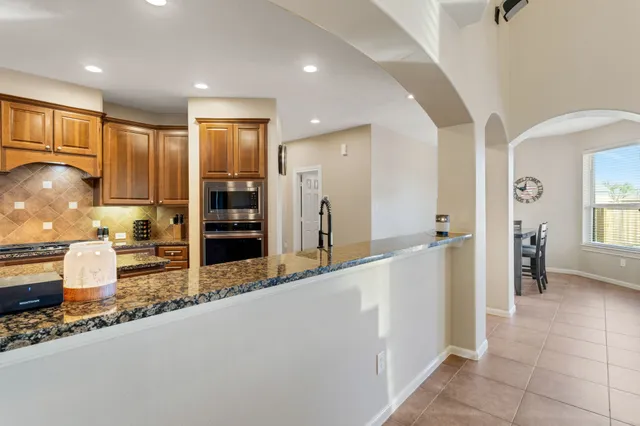 a large kitchen with a stove a sink and a refrigerator