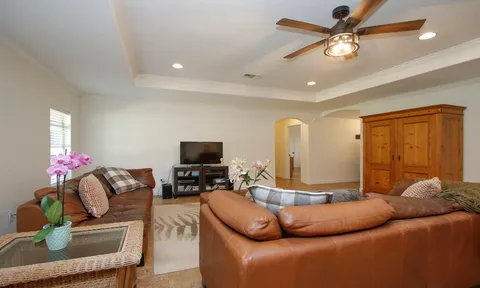 a kitchen with stainless steel appliances granite countertop wooden cabinets a sink a stove a refrigerator and a microwave