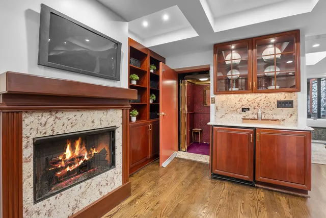 a hallway with fireplace and a fireplace