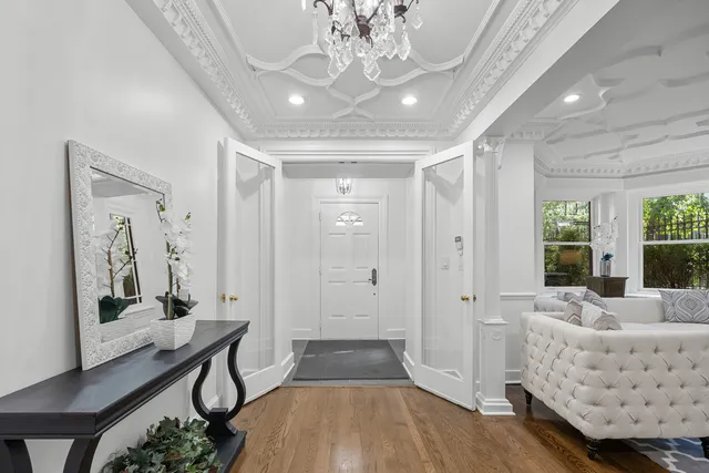 a living room with furniture and a chandelier