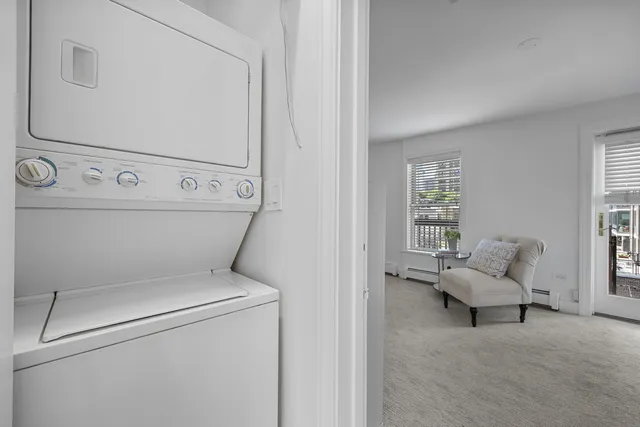 a view of a kitchen with a sink and dishwasher wooden cabinets with wooden floor