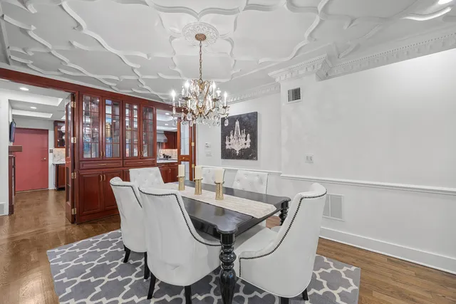 a view of a dining room with furniture and chandelier