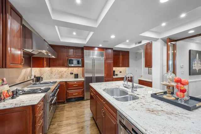 a kitchen with stainless steel appliances granite countertop sink stove and cabinets