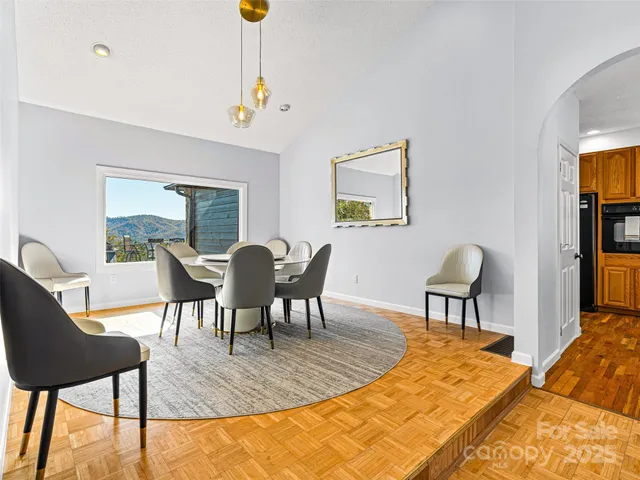 a view of a dining room with furniture and a potted plant