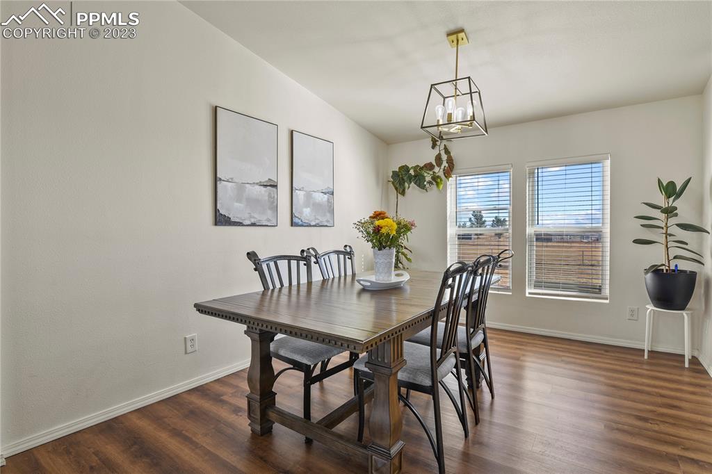 17755 Sage Crest Road Peyton, CO 80831 - Photo 11 of 37 a view of a dining room with furniture window and wooden floor
