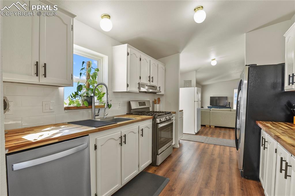 17755 Sage Crest Road Peyton, CO 80831 - Photo 14 of 37 a kitchen with granite countertop a sink stainless steel appliances and cabinets