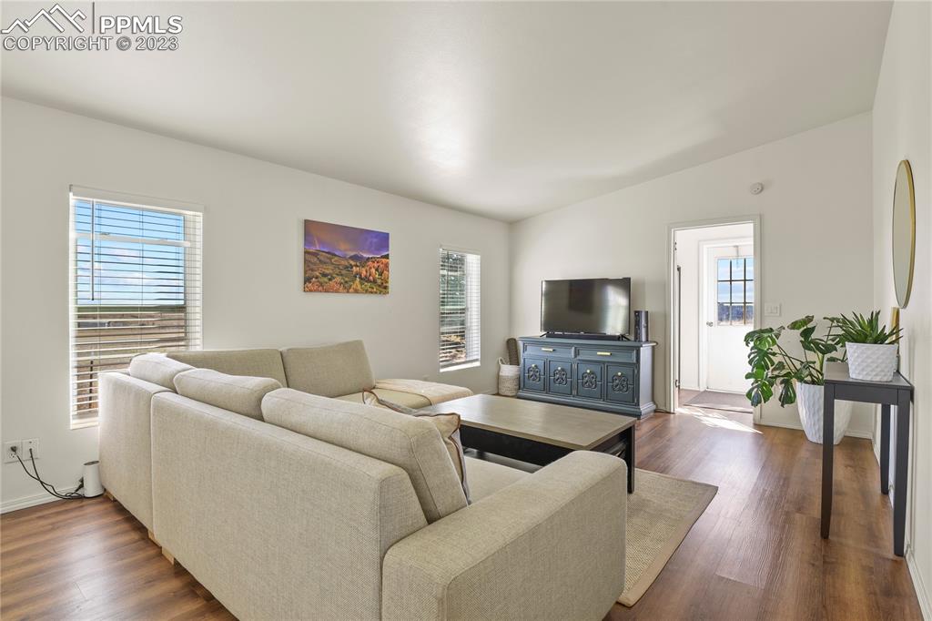 17755 Sage Crest Road Peyton, CO 80831 - Photo 17 of 37 a living room with furniture wooden floor and a flat screen tv
