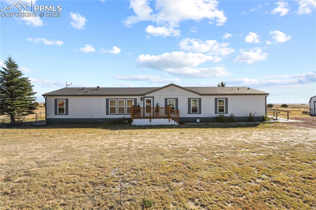 17755 Sage Crest Road Peyton, CO 80831 - Photo 2 of 37 a front view of a house with yard