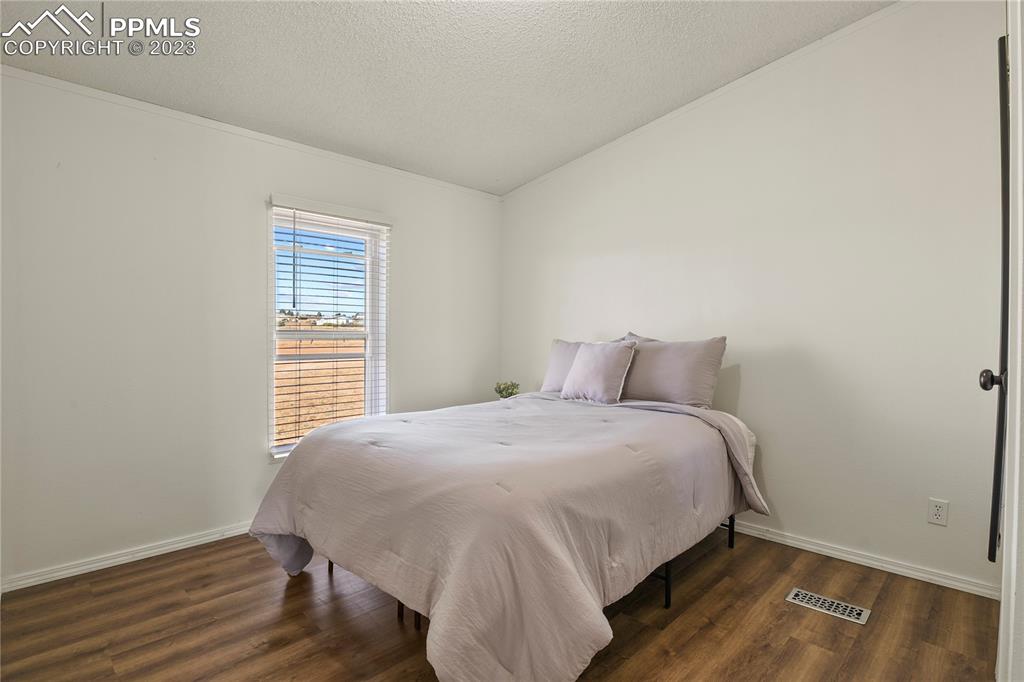 17755 Sage Crest Road Peyton, CO 80831 - Photo 24 of 37 a bed sitting in a bedroom next to a window
