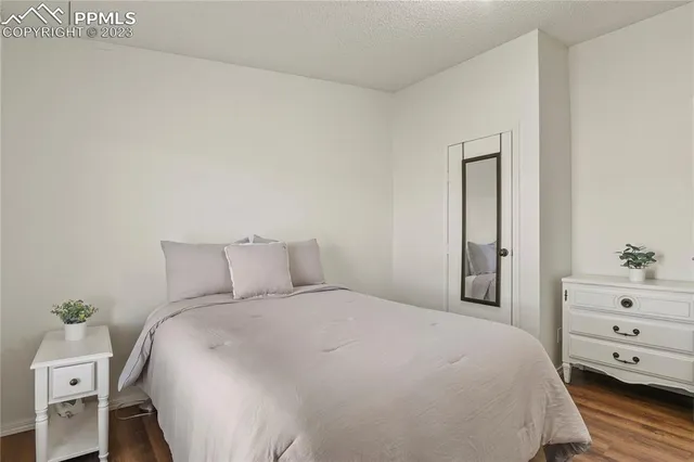 a bedroom with a bed and a dresser