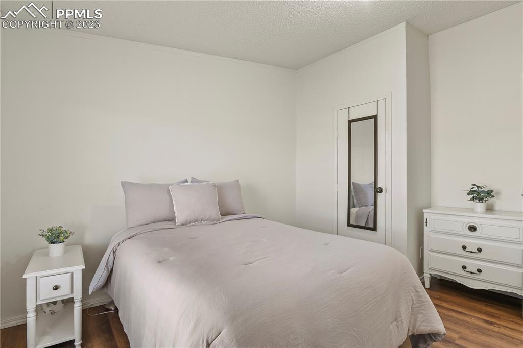 17755 Sage Crest Road Peyton, CO 80831 - Photo 25 of 37 a bedroom with a bed and a dresser