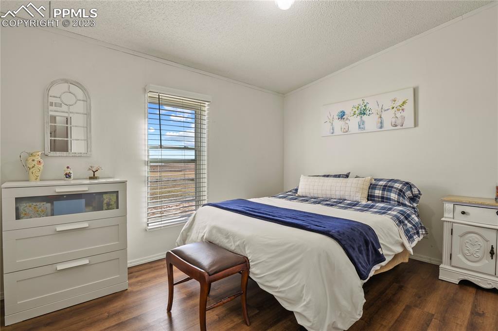 17755 Sage Crest Road Peyton, CO 80831 - Photo 28 of 37 a bedroom with a bed and a table