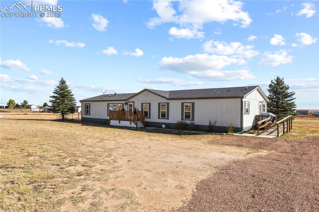 17755 Sage Crest Road Peyton, CO 80831 - Photo 3 of 37 a yellow house with trees in front of it