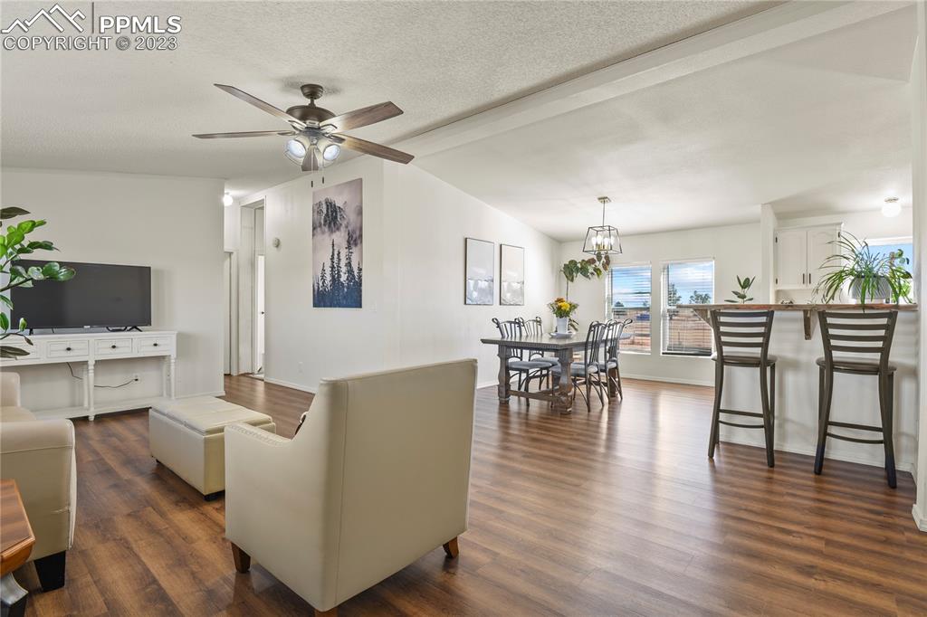 17755 Sage Crest Road Peyton, CO 80831 - Photo 7 of 37 a living room with furniture wooden floor and a flat screen tv