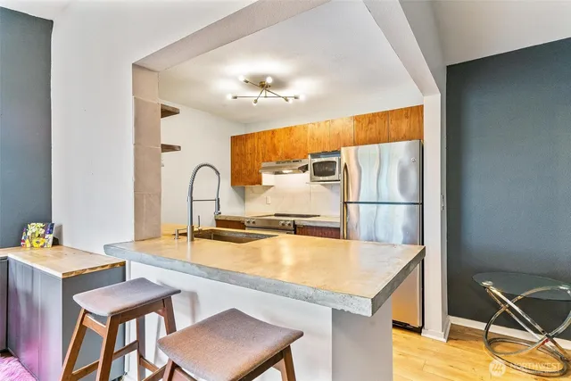 a kitchen with a table chairs and a refrigerator
