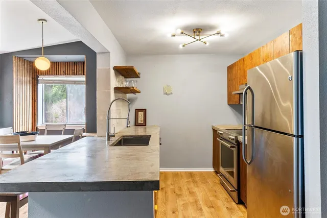 a kitchen with kitchen island a counter top space appliances and a counter space
