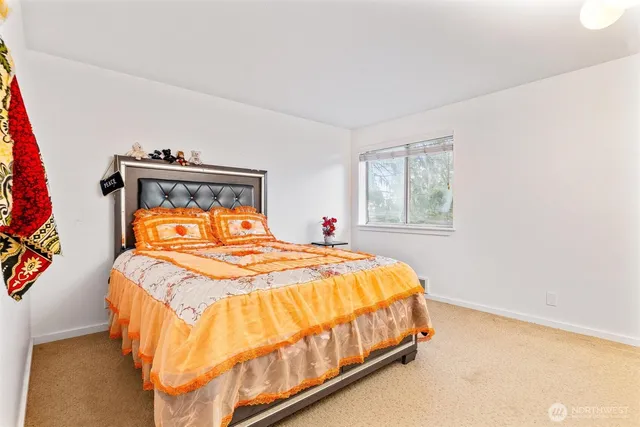 a bedroom with a bed and window