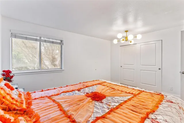 a bedroom with a bed and chandelier