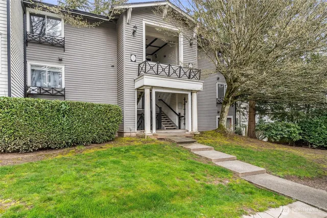 a view of a front of a house with a yard