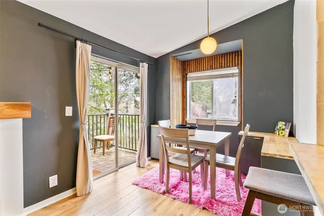 a view of a dining room with furniture window and wooden floor