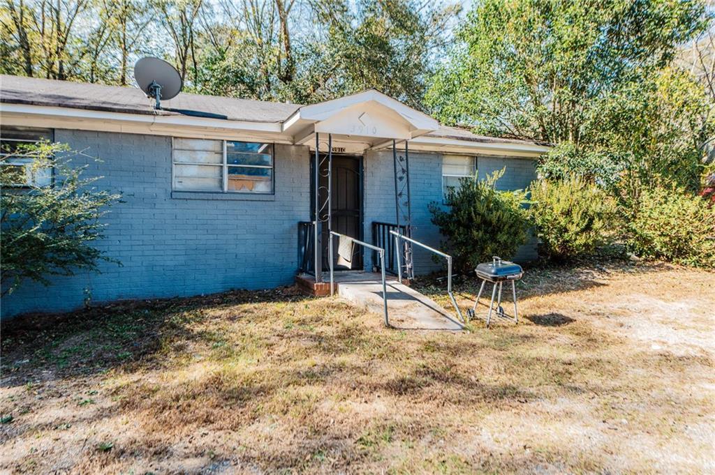 3908 Log Cabin Drive Macon, GA 31204 - Photo 2 of 2 a house with trees in front of it