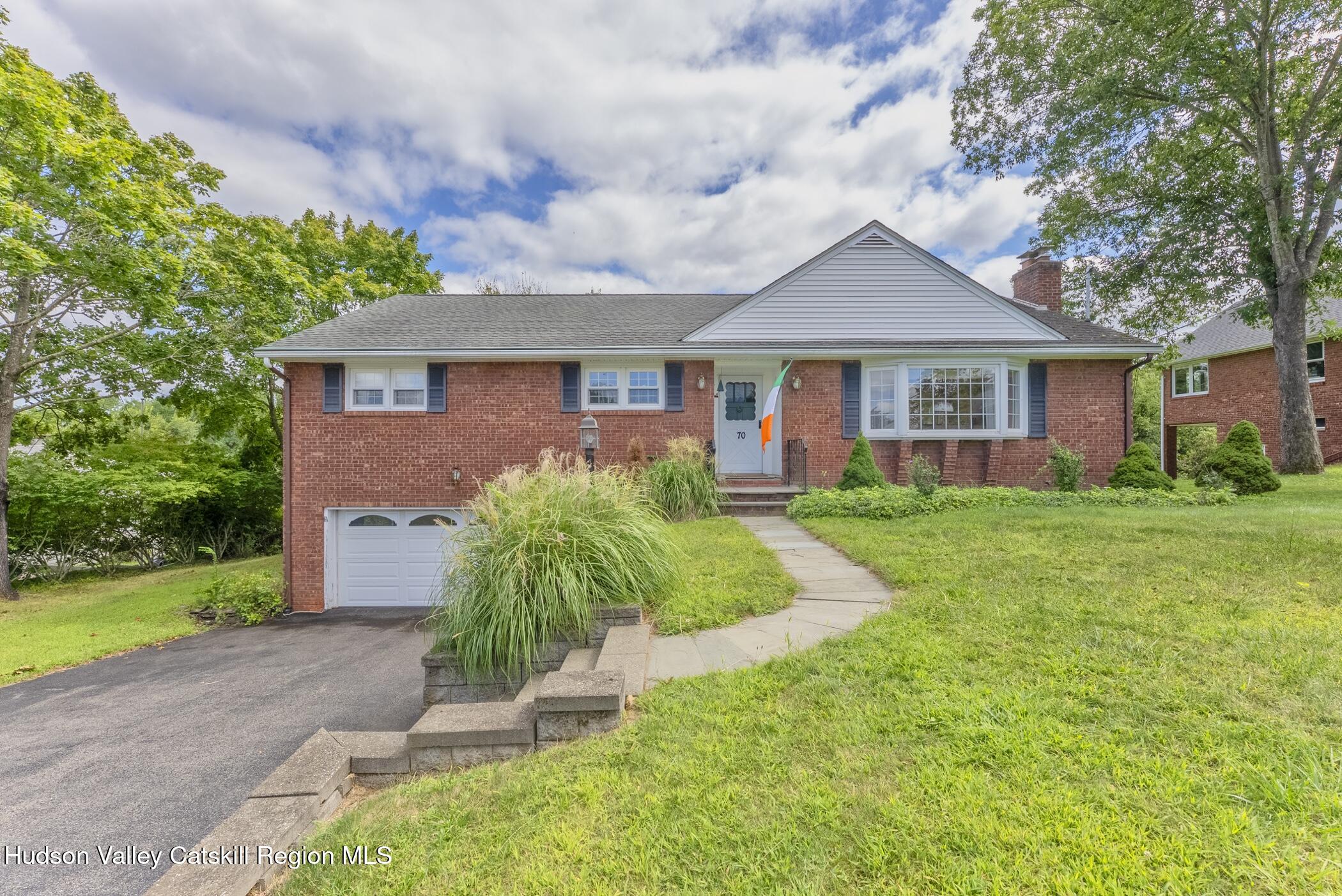 a front view of house with yard and green space