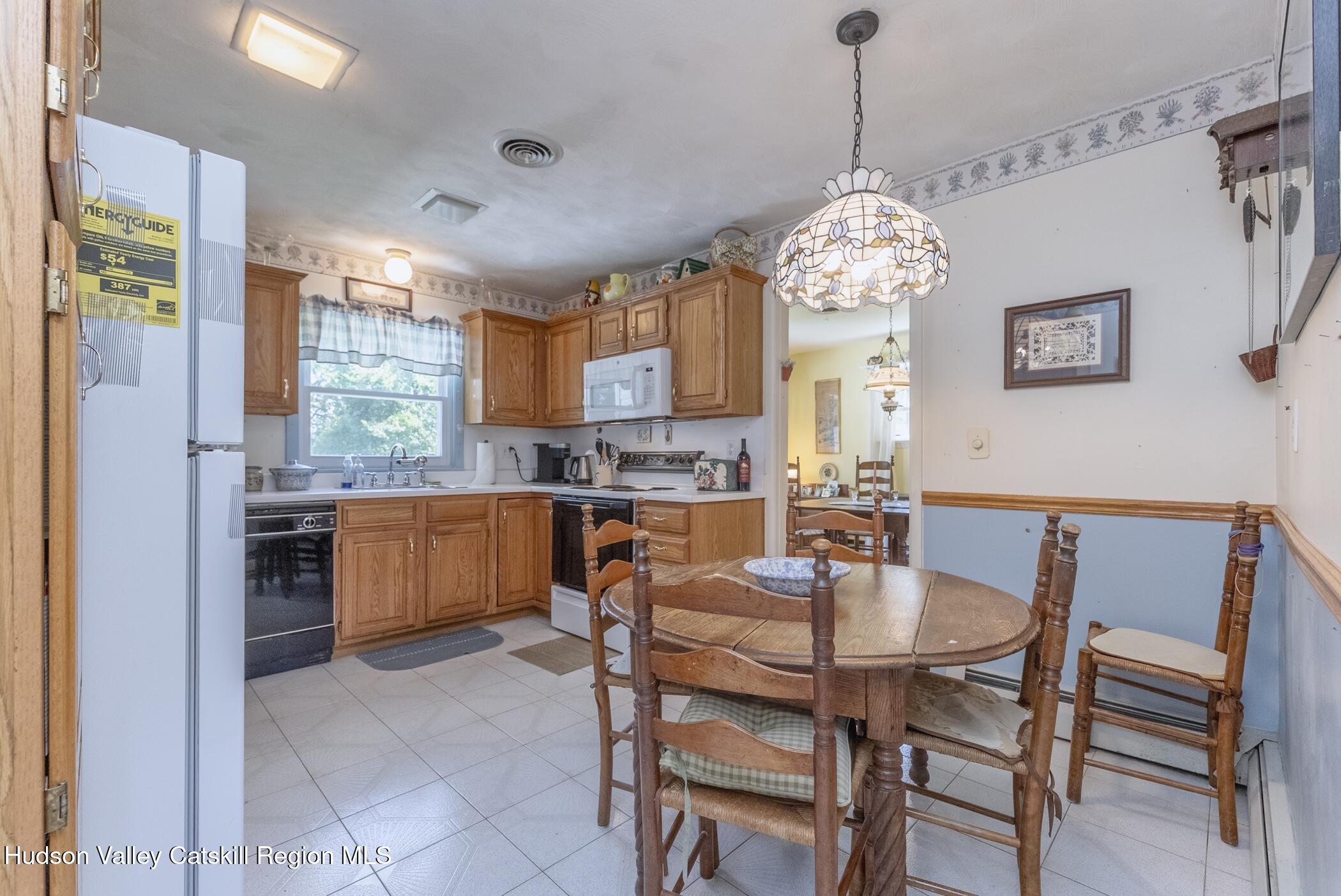 70 Ringtop Road Kingston, NY 12401 - Photo 12 of 47 a dining room filled a chandelier and kitchen view