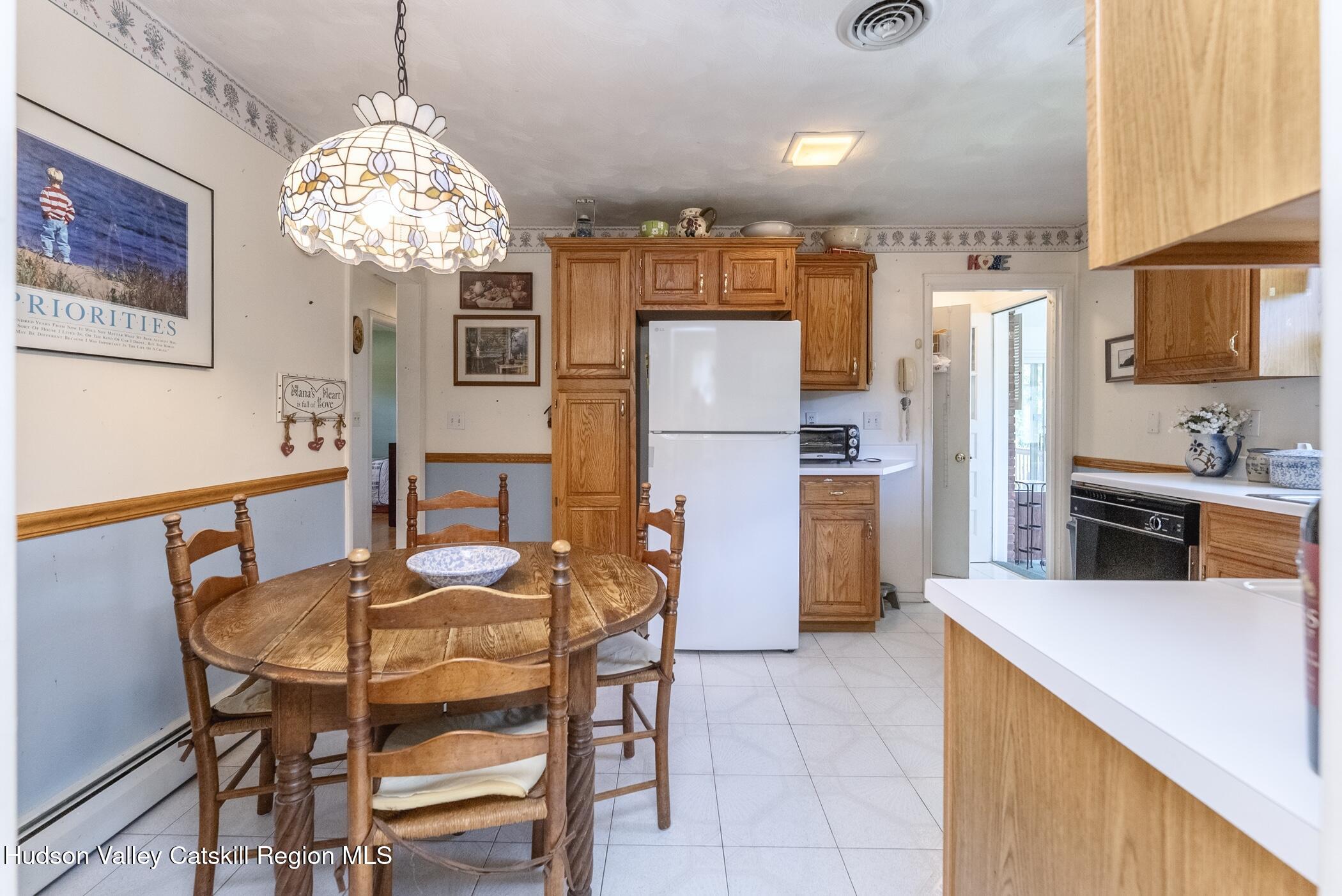 70 Ringtop Road Kingston, NY 12401 - Photo 13 of 47 a kitchen with stainless steel appliances granite countertop a refrigerator a stove a sink dishwasher and a dining table with wooden floor