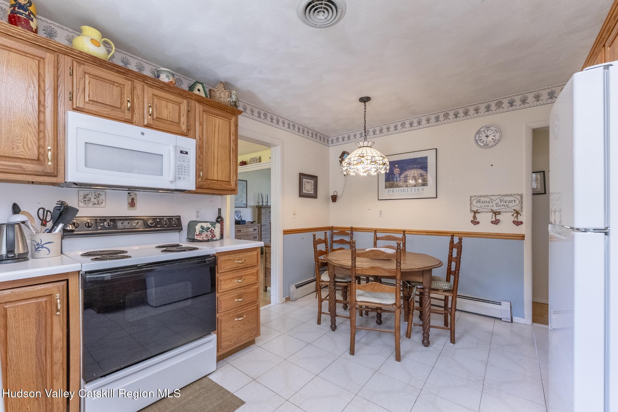 70 Ringtop Road Kingston, NY 12401 - Photo 16 of 47 a view of kitchen with stainless steel appliances granite countertop a stove a sink a dining table and chairs