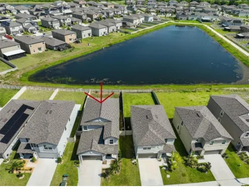 an aerial view of a house with a swimming pool