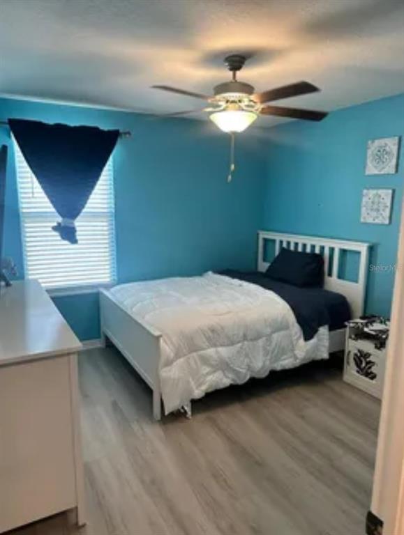 9317 Lemon Drop Loop Ruskin, FL 33573 - Photo 13 of 13 a bedroom with a bed and a chandelier