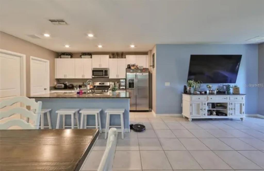9317 Lemon Drop Loop Ruskin, FL 33573 - Photo 3 of 13 a kitchen with stainless steel appliances a refrigerator and a stove top oven