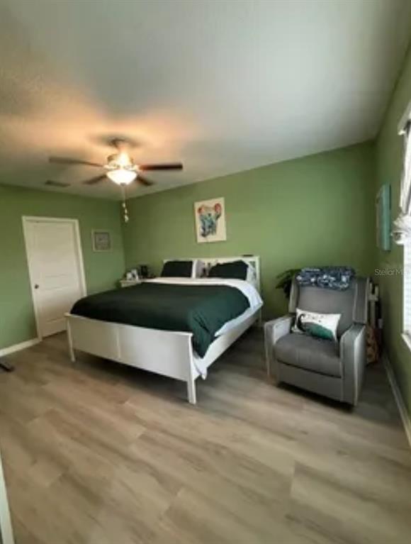 9317 Lemon Drop Loop Ruskin, FL 33573 - Photo 10 of 13 a spacious bedroom with a bed and a couch