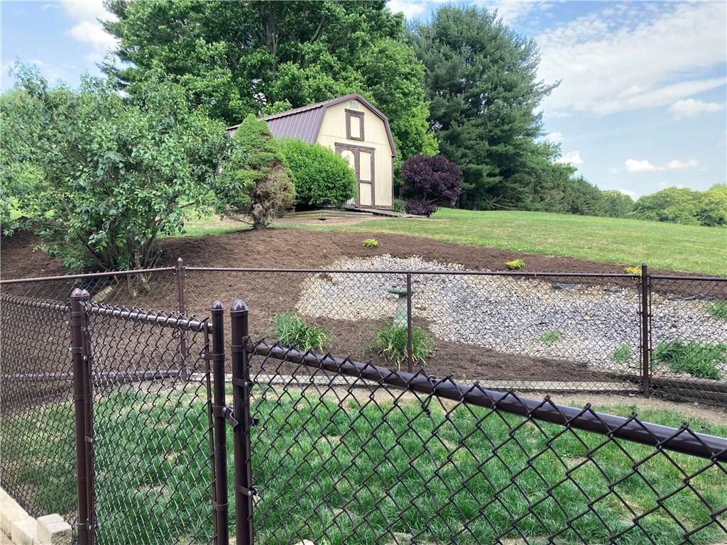26 Paxton Road Sandy Lake, PA 16145 - Photo 2 of 23 a view of a backyard with a garden and plants