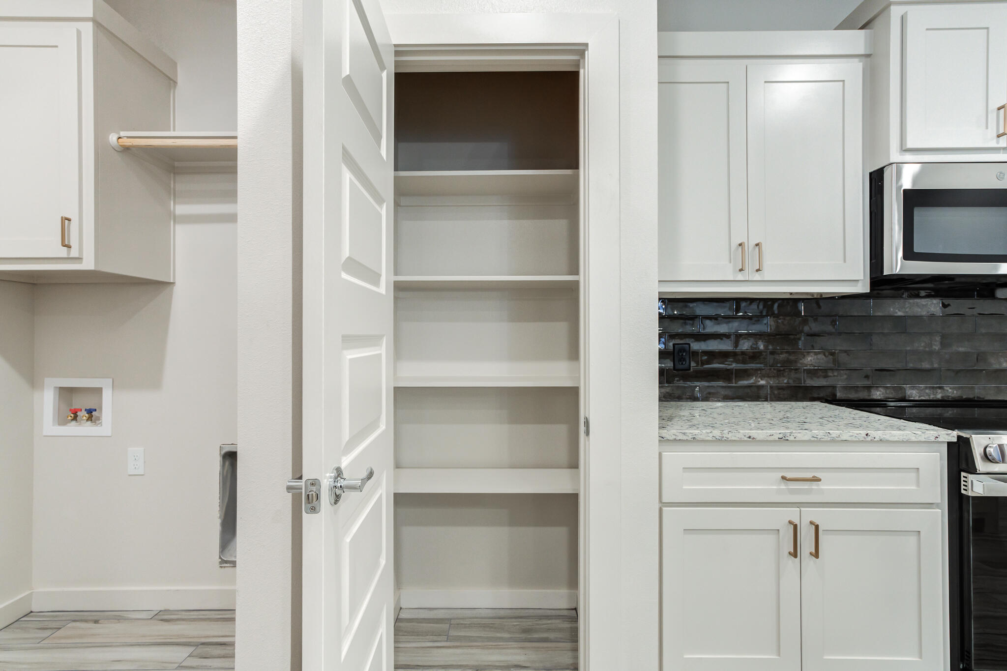 7044 41st Street Lubbock, TX 79407 - Photo 13 of 22 a kitchen with white cabinets and a sink