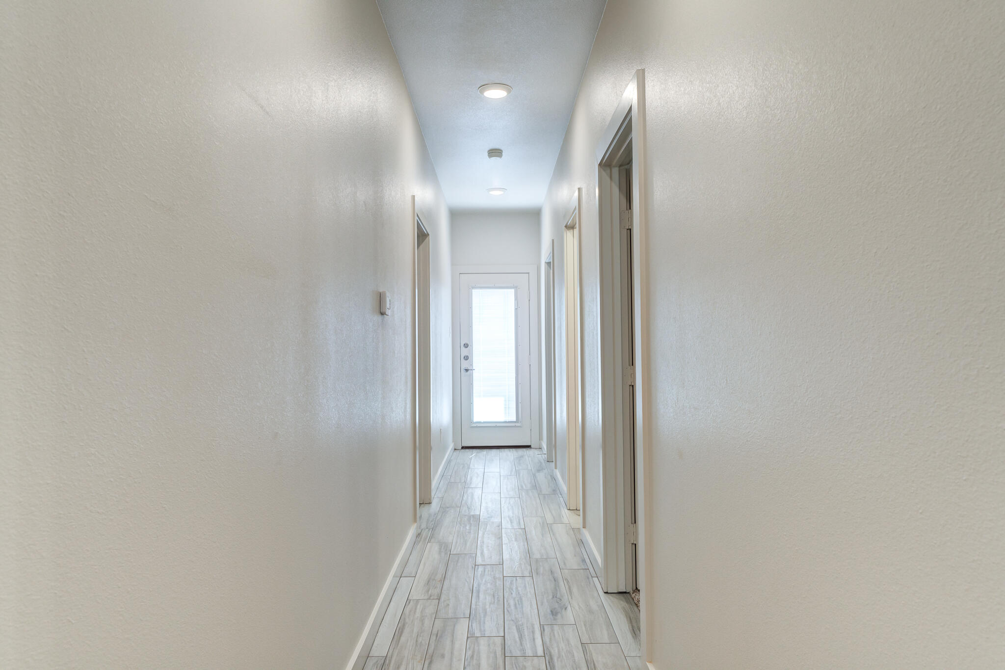 7044 41st Street Lubbock, TX 79407 - Photo 16 of 22 a view of a hallway with wooden floor
